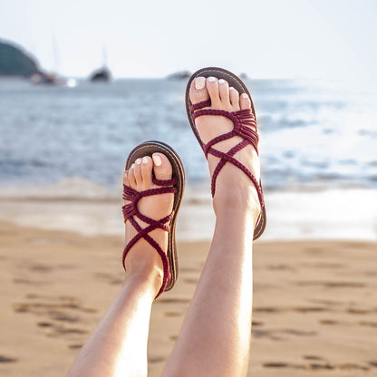Capana brand loop design Burgundy Hand-Woven Rope Sandals on model at the beach